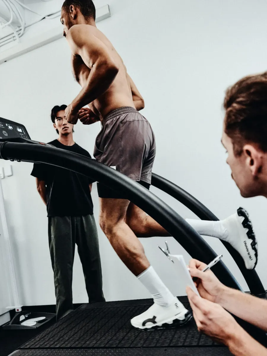 A physiotherapist observing a runner on a treadmill in the RunReady lab